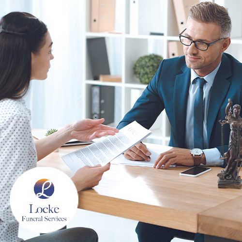 Female holding stack of legal documents speaking to a lawyer or law professional male
